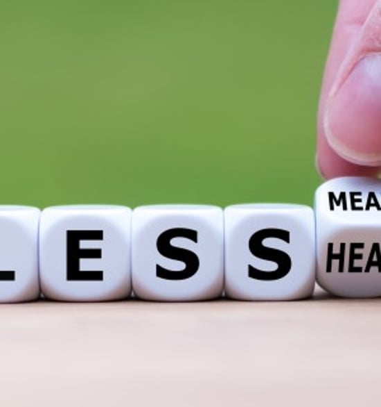 White dice lined up spelling out Eat Less Meat