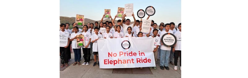 Young participants hold artwork and banners promoting wildlife conservation during a World Environment Day event in Jaipur.